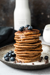 Wall Mural - Oat pancakes with blueberry, chocolate and honey. Healthy pancakes. Healthy breakfast or snack concept. Closeup view stack of pancakes
