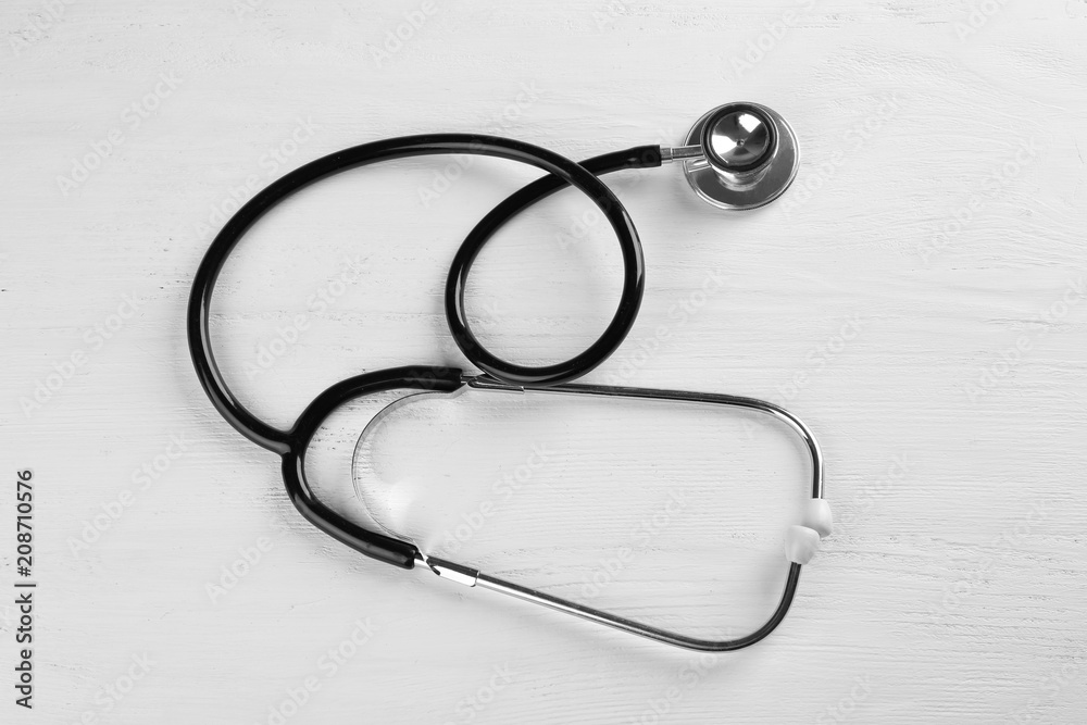 Stethoscope on white wooden background