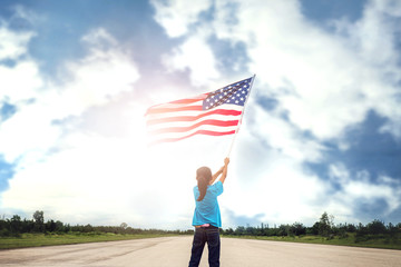 Happy kid little child standing with American flag USA celebrate 4th of July