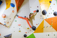 Young Woman Climbing Challenging Bouldering Route