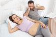 © Viacheslav Yakobchuk - Irritating snore. Pregnant woman snoring while upset man staring at her