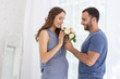 © Viacheslav Yakobchuk - Nice flowers. Merry pregnant woman and man smiling and holding flowers
