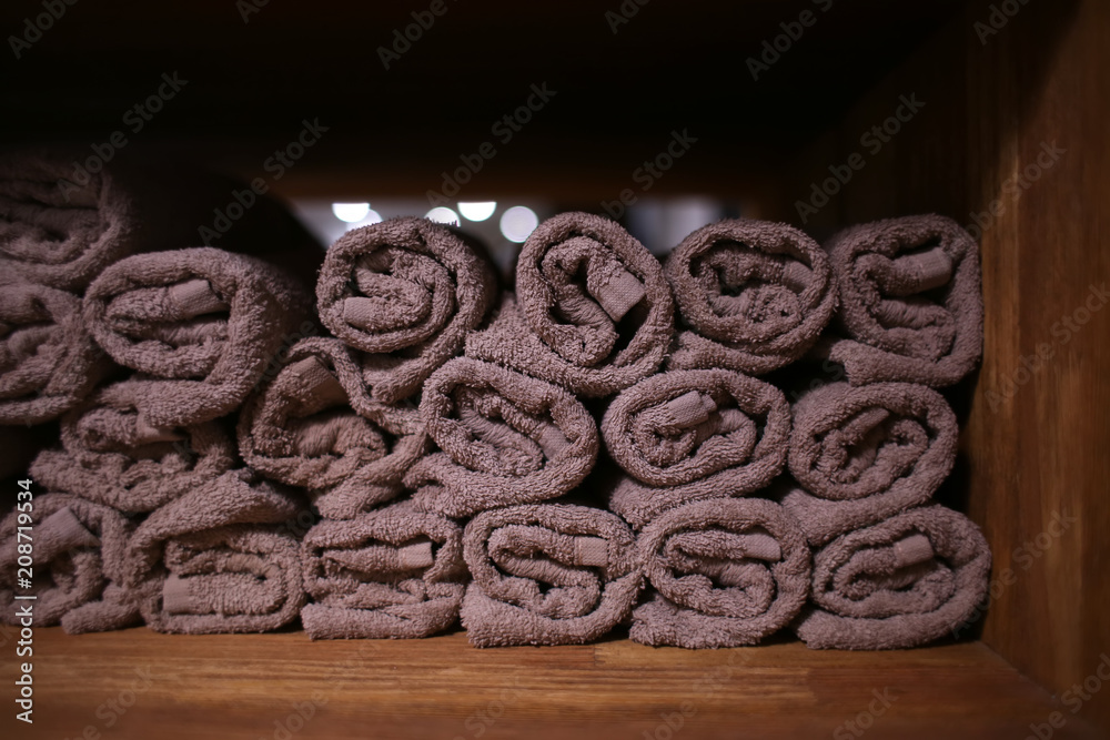 Clean soft towels on shelf in hairdressing salon
