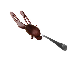 Spoon and molten chocolate on white background