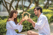 © May Chanikran - Happy smiling couple holding model house with dreaming together.