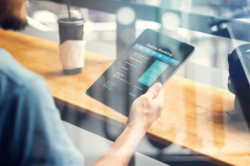 Aufkleber - Man hand using online banking on tablet screen device in coffee shop. Technology Ecommerce Commercial. Online payment digital and shopping on network connection. All on tablet screen are designed up.