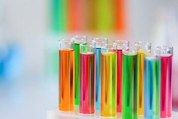 Test tubes with colorful samples in laboratory, closeup