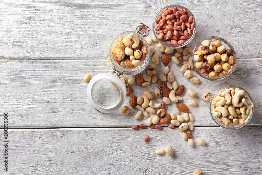 Composition with different nuts on wooden background