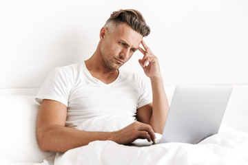 Wall Mural - Concentrated man using laptop computer