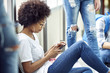 © PhotoAlto - Female student using smartphone during break at school