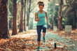 © Microgen - Woman Exercising Outdoors in The Fall