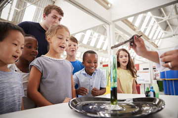 group of kids and teachers carrying out a science experiment
