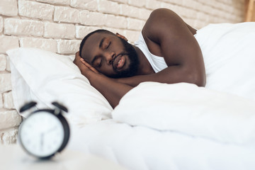 African American man sleeps in bed