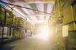 Cargo cardboard boxes in logistic storage warehouse, interior of storehouse inside with sunlight