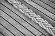 © MaciejBledowski - Thick rope on an old sailing ship wooden deck, selective focus.