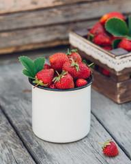 Wall Mural - Fresh juicy strawberries with leaves. Rustic wooden box and handmade lace, enameled mug. Retro magazine picture.