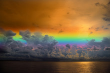 Sunset Sky Rainbow Over Silhouette Orange Cloud On The Sea