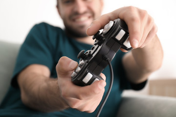 Wall Mural - Young man playing video games at home