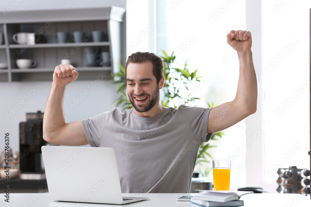 Male freelancer working with laptop in home office