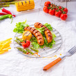 grilled krakauer sausage with boiled corn and green salad