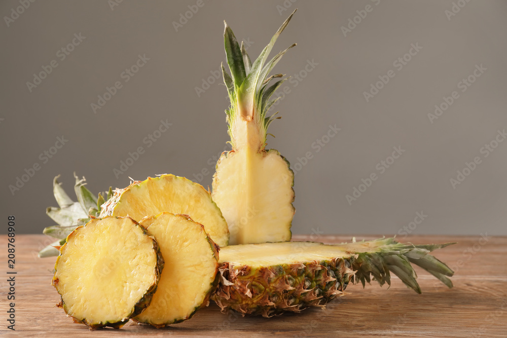 Composition with delicious sliced pineapple on wooden table