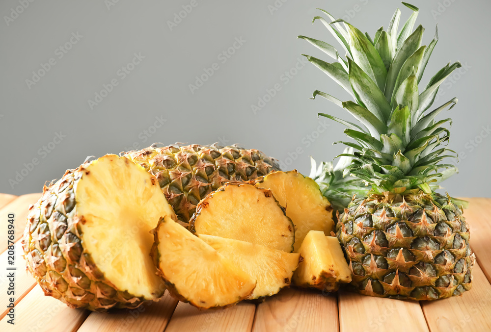 Composition with delicious sliced pineapple on wooden table