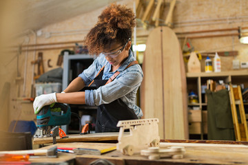 Wall Mural - Afro american woman craftswoman working in her workshop

