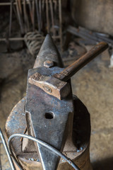 Wall Mural - Old Sledge on an anvil in a workshop