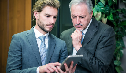 Business people using a tablet in their office