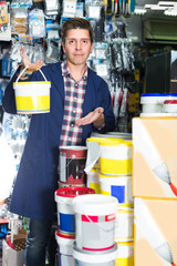 Wall Mural - Worker in hardware store is trading goods