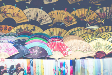 Wall Mural - Traditional handicraft chinese fans at market in Yangshuo, China.