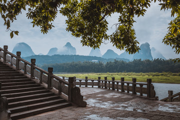 Wall Mural - Scenic landscape at Yangshuo County of Guilin. Li River (Lijiang River). Pleasure boats at the pier in Yangshuo Town, China.