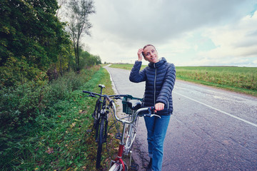 Wall Mural - Hobby and leisure. Young woman with bicycle outdoor.