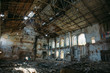 Ruins of abandoned old broken industrial factory or warehouse buildings after disaster, war or cataclysm