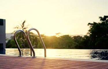 Swimming pool in sunset time.