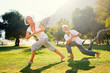 © luengo_ua - Yoga at park. Senior family couple exercising outdoors. Concept of healthy lifestyle.