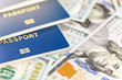 © Kyryl Gorlov - Three biometrical international passports over money background. Blue travel documents lying on US one hundred dollar banknotes. Family tourism and travelling abroad concept