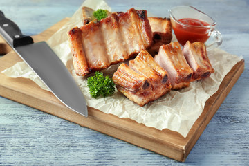 Sticker - Wooden board with delicious grilled ribs on table