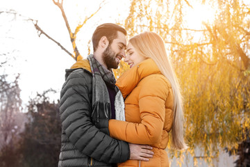 Canvas Print - Young romantic couple hugging outdoors