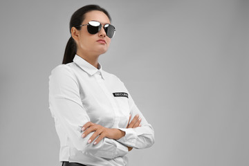 Wall Mural - Female security guard in uniform on color background