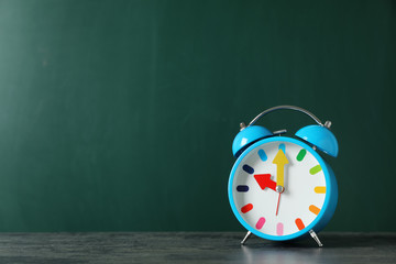 Poster - Alarm clock on table against color background. Time concept