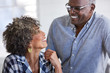 © trinettereed/Stocksy - Senior African American couple at home smiling at each other