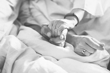 closeup of couple holding hands together