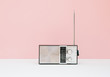 © kkgas/Stocksy - Vintage transistor radio in front of pink background