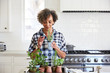 © trinettereed/Stocksy - Senior African American woman with fresh herbs in her kitchen