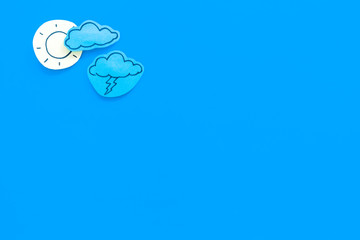 Wall Mural - clear and cloudly weather icons on blue background top view copy space