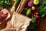 Fototapeta Mapy - Male hands hold paper bag healthy food buying healthy food