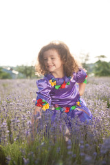 happy beautiful caucasian little girl fairy purple dress among lavender fields