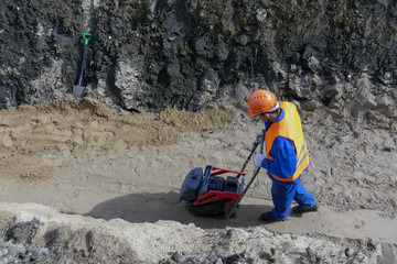 Wall Mural - guest worker is building a trench sand stone earth