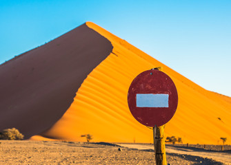 Wall Mural - Stop sign in front of sand dune in Sossusvlei, Namib-Naukluft National Park, Namibia